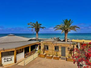 a house on the beach with palm trees and the ocean at Hotel & Restaurant San Pellegrino in Folelli +75 photos