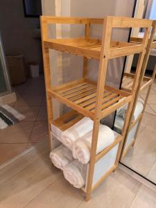 a wooden towel rack with towels in a bathroom at Centurion La Creme Apartments in Centurion +18 photos