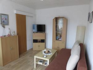 a living room with a couch and a table at Bungalow Alms in Ribnitz-Damgarten