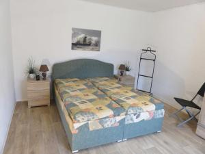 a bedroom with a bed and a table and a chair at Bungalow Alms in Ribnitz-Damgarten