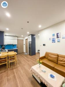 a living room and kitchen with a couch and a table at It Dust Homestay 1 - The Ocean Apartment in Hanoi