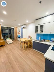 a kitchen and living room with a table and chairs at It Dust Homestay 1 - The Ocean Apartment in Hanoi +26 photos