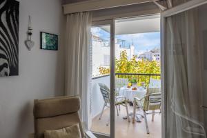 a dining room with a table and chairs on a balcony at Marian Gola in Port de Pollensa