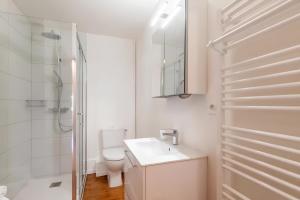 a white bathroom with a toilet and a sink at Maison Jumelée avec terrasse - A 200m du lac d'Annecy in Sévrier +27 photos