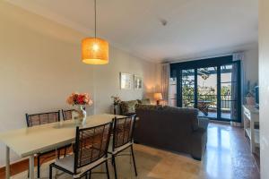 a living room with a table and a couch at El Rincon del Golf II PLUS by Ĥ - Isla Canela Golf GRHII27P30 in Isla Canela