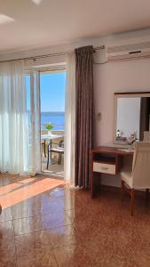 a living room with a desk and a view of the ocean at Apartmani Adriatica 2 in Dramalj