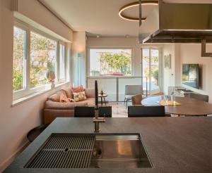 a kitchen and living room with a sink at Palazzo Delle Pietre - Luxury Apartments in Rome