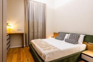 a bedroom with a large bed with a window at Duomo 9 - Luxury Modern Loft in Milan