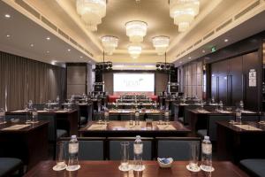a large room with tables and chairs and a screen at Green Beach Hotel Nha Trang in Nha Trang