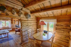a dining room with a table in a log cabin at Charming Cabin with Old Timber, Fireplace & Views in Beitostøl +26 photos