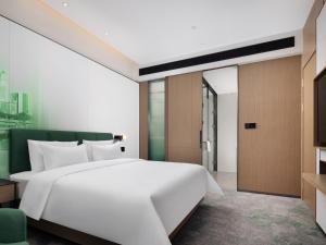 Postelja oz. postelje v sobi nastanitve Hampton by Hilton Dongguan Liaobu Songshan Lake Avenue