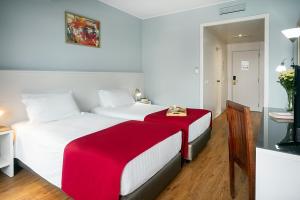 Postel nebo postele na pokoji v ubytování Hotel Estacão - Braga