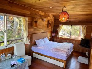 Postel nebo postele na pokoji v ubytování Lala Mountain San hao Manor