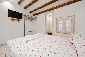 Posteľ alebo postele v izbe v ubytovaní Apartman tutto bene