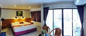 a hotel room with a bed and a balcony at Leng Hotel in Hua Hin