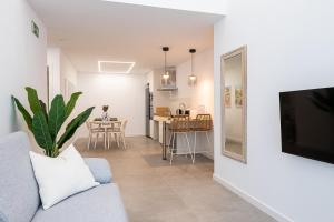 a living room with a couch and a tv at Main Lofts Valencia in Valencia