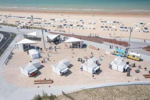 an aerial view of a beach with white tents at Chez Francois in Ardres