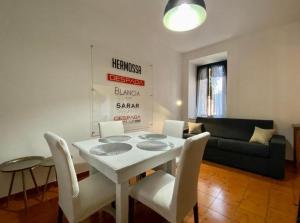 a living room with a white table and chairs at Malpensa Guest in Case Nuove +11 photos