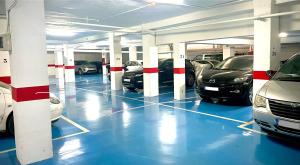 a parking garage with cars parked in it at Itinere Rooms in Granada