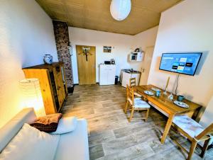 a living room with a couch and a table at FeWo Elbtalaue in Lanz