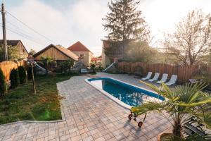 a backyard with a swimming pool and a fence at Rácz Kúria in Racoşu de Sus