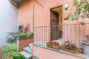 a balcony with potted plants on a house at Casa Pertinace in Alba