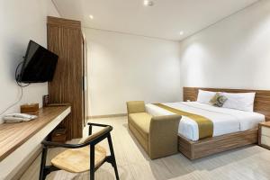 Krevet ili kreveti u jedinici u okviru objekta Rasuna Icon Hotel