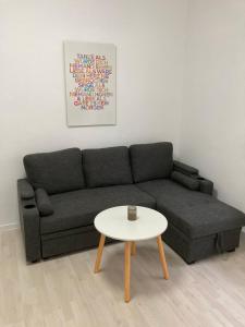 a living room with a couch and a table at 2-Zimmer-Ferienwohnung 55 qm, bei Berlin in Velten
