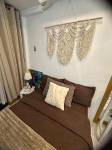 a bedroom with a large bed and curtains at Cozy Place with City View at Greenbelt Makati in Manila
