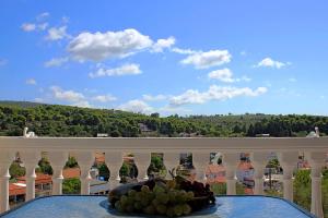 a plate of fruit on a table on a balcony at Casa Campanario Villa - Charming Nature Villa with Pool in a Picturesque Village By Villa Mana Gers in Agios Leon