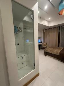 a glass door leading to a bedroom with a bed at Cozy Place with City View at Greenbelt Makati in Manila