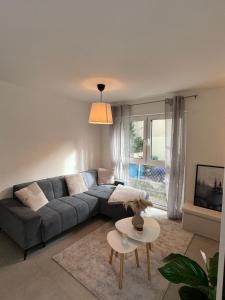 a living room with a couch and a table at City Residenz , Europa-Park - Rulantica in Lahr