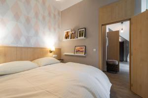 Ένα ή περισσότερα κρεβάτια σε δωμάτιο στο Moderný apartmán Swen s 2 terasami Tatranská Lomnica