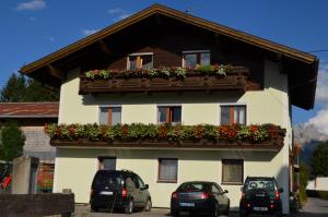 a building with two cars parked in front of it at Haus Sennweg in Tannheim +11 photos