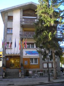 a building with flags in front of it at Auto Check In Hotel Las Nieves in Jaca