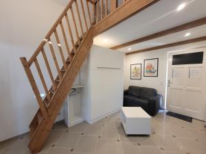 a living room with a staircase and a couch at Le CHALET in Créteil
