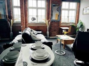 a living room with a couch and a table at City Mill - Next to Town Centre Shopping and Restaurants - Free Parking in Burton upon Trent