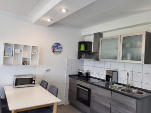a kitchen with a sink and a counter top at Ferienhaus Seeperle in Tossenserdeich