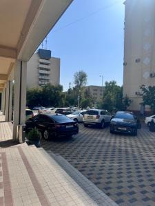 a group of cars parked in a parking lot at Hotel OK in Tashkent