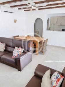 a living room with a couch and a table at Apartamento Berdica in Benitachell