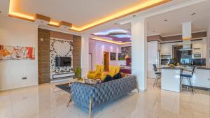 a living room with a couch and a kitchen at villa vinka in Kalkan