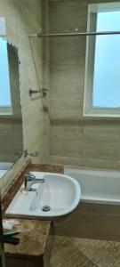 a bathroom with a sink and a bath tub at Jlt L cluster preatoni tower in Dubai