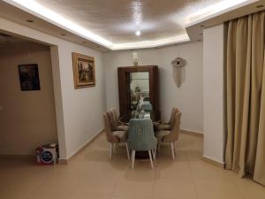 a dining room with a table and chairs at طيبة جاردنز أكتوبر in 6th Of October