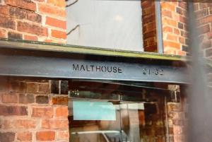 a sign for a meth house on a brick wall at Safari Lodge - Close to Shopping Centre and Restaurants, Free Parking, Stylish and Amazing Artwork in Burton upon Trent