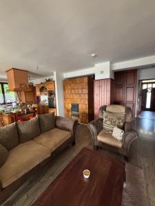 a living room with a couch and a table at Parti Apartman in Balatonfůzfő