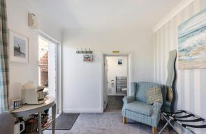 a living room with a chair and a table at Beach room in Ayr