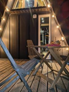 a table and a chair sitting on a deck at Солодка Мить in Slavske +42 photos