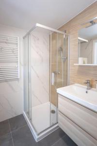 a bathroom with a shower and a sink at Apartment Kaptol in Zagreb