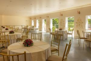 a banquet hall with tables and chairs with flowers on them at Royal Heritage Haveli - By Leisure Hotels in Jaipur