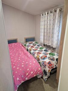 a bedroom with two beds with hello kitty sheets at Cresswell Towers in Morpeth